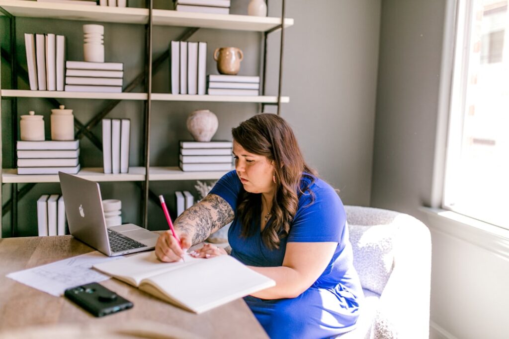Business owner planning a virtual assistant role at a desk